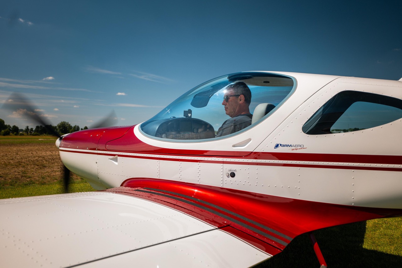 The founder seated in his Bristell NG5 with the canopy open on the ramp
